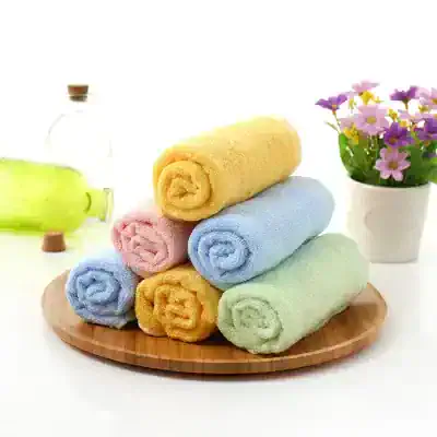 Towels stacking on wooden plate for Monalisa Medical store, colorful towels in pastel shades, soft and plush material, bathroom or spa essentials, with flower vase in background, hygiene and wellness products, clean aesthetic, high-quality fabric, relaxing bathroom accessories relevance.