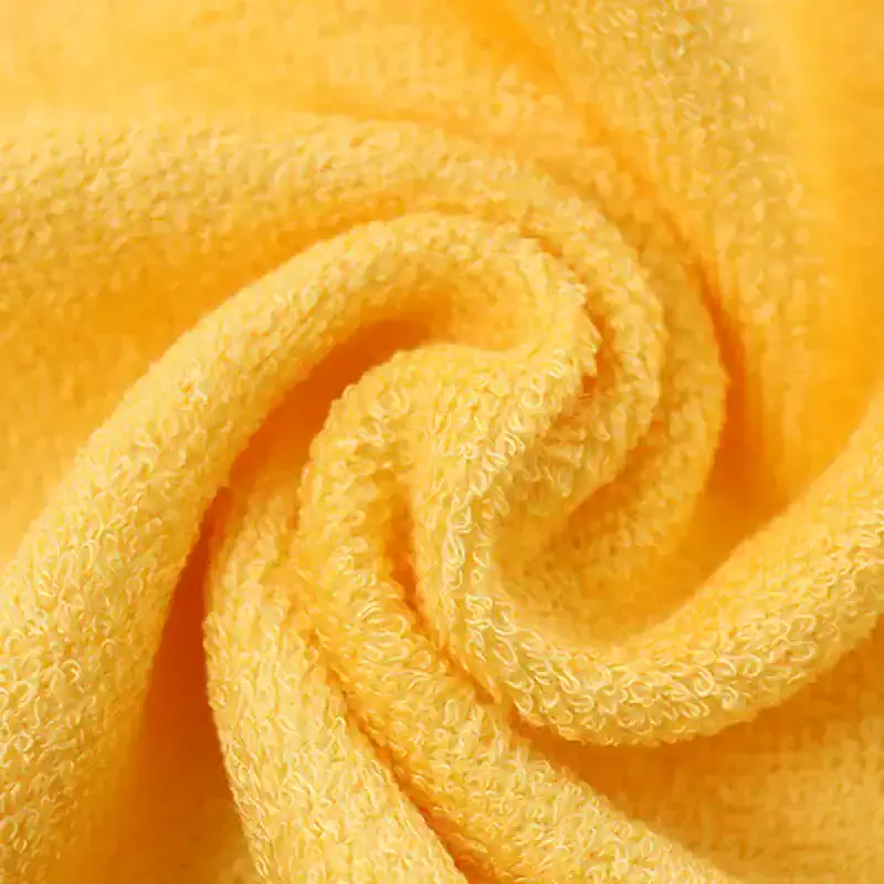Bright yellow microfiber cleaning towel, plush and textured fabric, ideal for cleaning lenses and delicate surfaces at Monalisa Medical Store.