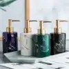 Elegant marble-design liquid soap dispensers with gold pumps, perfect for modern bathroom or kitchen decor - available at Monalisa Store.