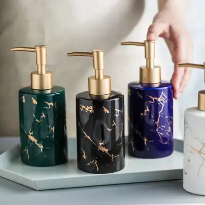 Luxurious marble-patterned soap dispensers with gold pumps, perfect for high-end bathroom and skincare storage. Stylish design elevates your beauty space with elegant, marble-inspired aesthetic.