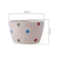 Colorful polka dot ceramic planter for stylish home decor and indoor plants. Bright, playful design perfect for modern living spaces. Add vibrancy to your home with this decorative flower pot.