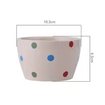 Colorful polka dot ceramic planter for stylish home decor and indoor plants. Bright, playful design perfect for modern living spaces. Add vibrancy to your home with this decorative flower pot.