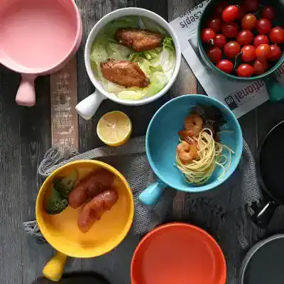 Colorful coffee mugs filled with various dishes on a rustic wooden table, featuring fresh vegetables, pasta, and lemon, ideal for promoting healthy eating, food, and dining concepts in the Monalisa Store context.
