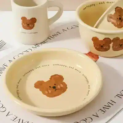Cute teddy bear design on ceramic mug, bowl, and plate set from Monalisa Medical, perfect for adding a playful touch to your tableware collection and expressing a lighthearted mood.