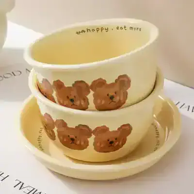 Cute bear-themed ceramic bowl set, ideal for serving snacks or small meals; features playful