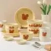 Cute teddy bear themed ceramic dinnerware set from Monalisa Store, ideal for children's dining, featuring plates, bowls, and mugs with playful bear designs.