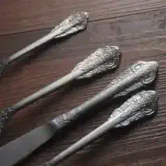 Antique silver Chinese-style tea tongs with intricate dragon engravings, perfect for traditional tea ceremonies and decorative display.