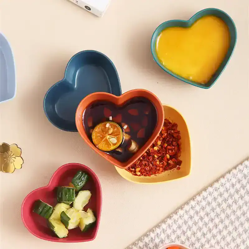 Vibrant heart-shaped bowls with condiments and garnishes for healthy eating or spa treatments at Monalisa Store.