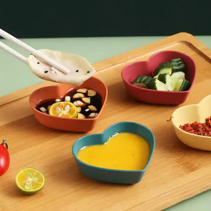 Colorful heart-shaped bowls with dipping sauces and fresh vegetables on wooden tray at Monalisa Medical Store, emphasizing health, diet, and wellness products.