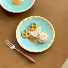 Miniature dessert plate with a cupcake, pretzels, and a cookie, perfect for dolls or collectibles. Bright pastel colors and detailed handcrafted design. A charming addition to any dollhouse or display collection.