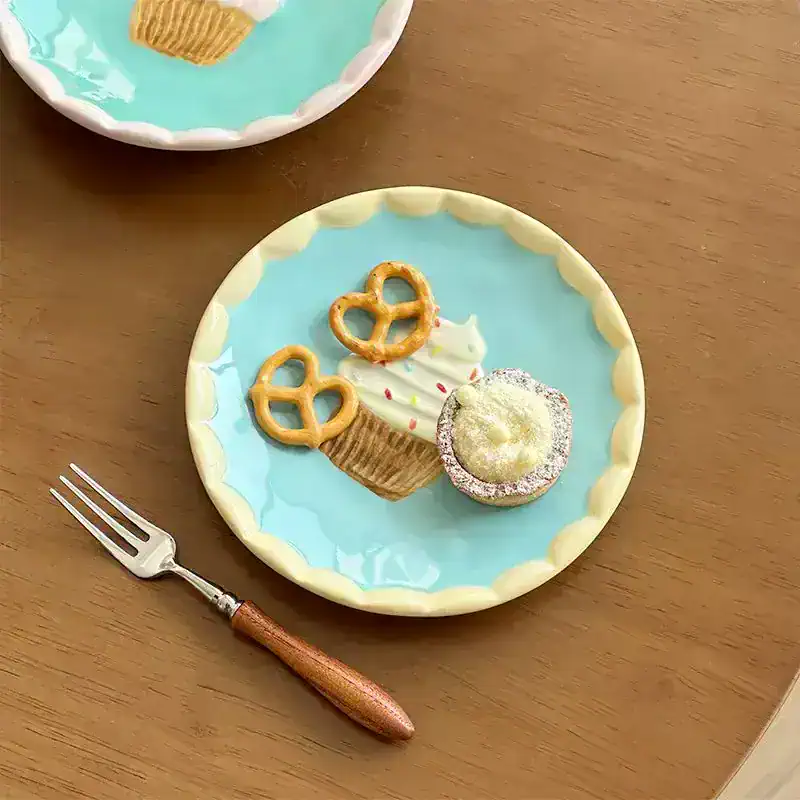 Miniature dessert plate with a cupcake, pretzels, and a cookie, perfect for dolls or collectibles. Bright pastel colors and detailed handcrafted design. A charming addition to any dollhouse or display collection.