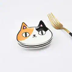 Colorful cat face plates for serving, featuring trendy artistic design with a gold fork included. Perfect for stylish dining and entertaining, adding fun to your table setting.