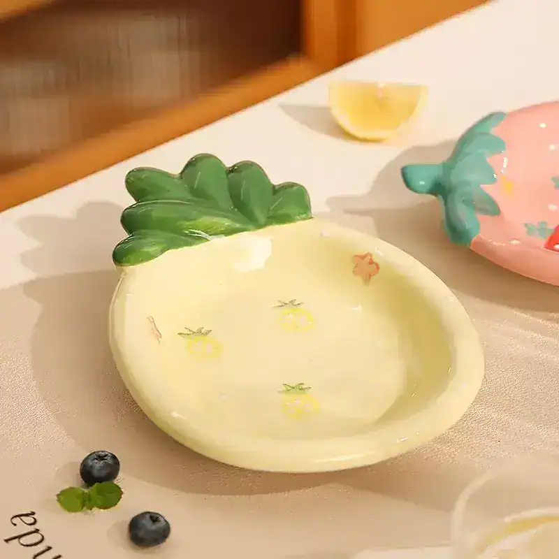 Pineapple-shaped ceramic dish with green leafy top, colorful glaze, and small fruit motifs, ideal for serving or decorative use at Monalisa Medical store.