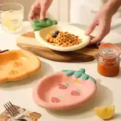 Handmade ceramic strawberry-shaped bowls for salads, desserts, or snacks, featured at Monalisa Store. Perfect for adding a charming touch to your tableware collection.