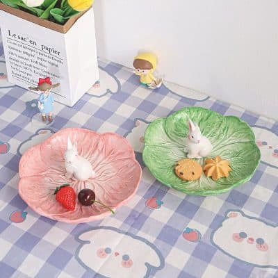 Cherry and strawberry ceramic bunny snack plates with cute animal-themed decorated ceramic dishes for snacks or dessert presentation.