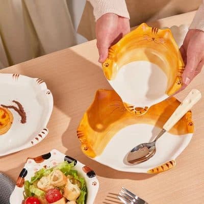 Cute cat-shaped ceramic bowl with tiger stripe design for serving snacks or desserts. Perfect for pet-themed kitchenware and cat lovers. Adds a playful touch to dining and snack presentations.