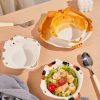 Cat-shaped ceramic bowls with orange, white, and black patterns, set on a light wooden table with a small salad dish, spoon, and fork, perfect for stylish tableware at Monalisa Store.