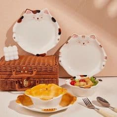 Colorful cat-themed ceramic plates and bowls, perfect for stylish dining, displayed with a wicker gift box and salad, ideal for enhancing your tableware collection at Monalisa Store.