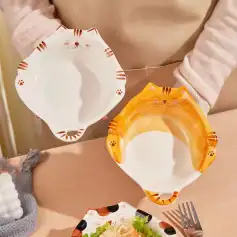 Cute cat-shaped ceramic plates with paw print details, perfect for children’s meals or playful dining, featuring cheerful orange and white designs at Monalisa Store.