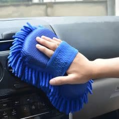 Microfiber cleaning cloth being used to clean a car dashboard, emphasizing automotive care and interior cleaning from Monalisa Store.