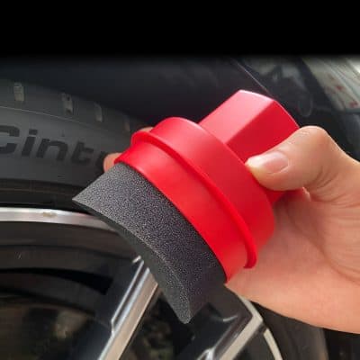 Flexible tire cleaning brush with handle for easy maintenance and tire shine enhancement in automotive detailing.