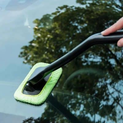 Microfiber cleaning pad on a squeegee used to clean car windshield, suitable for automotive detailing.