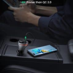 QC 3.0 fast charging port and modern smartphone on car dashboard, emphasizing quick device power-up technology.