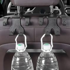 Water bottles attached to a car seat headrest for passengers' convenience and hydration on the go.