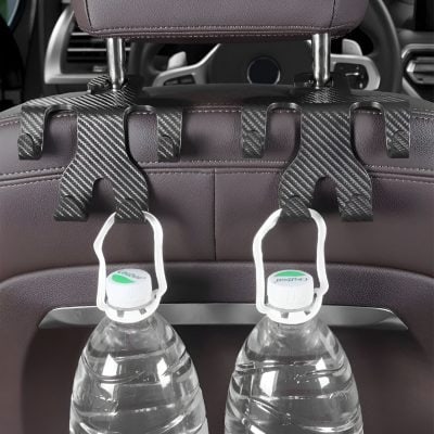 Water bottles attached to a car seat headrest for passengers' convenience and hydration on the go.