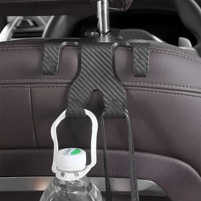 Car headrest with a carbon fiber clip holder for water bottles, designed for convenience during travel or medical appointments, showcasing innovative storage solutions.