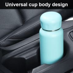 Stainless steel vacuum insulated water bottle in a car cup holder, ideal for travel and outdoor activities.