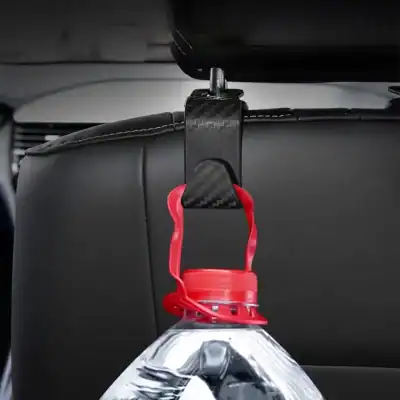 Bottle holder for car headrest with red strap and carbon fiber bracket, designed for easy access to water bottles during travel, enhancing convenience and hydration on the go.