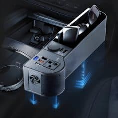 Wireless charging dock with sunglasses and electronic accessories in a luxury car interior, showcasing modern automotive technology and premium design.
