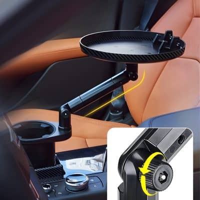 Car dashboard tray with adjustable mount for mobile devices, made of sleek black material, designed for secure and convenient use on the road; compatible with various car models.