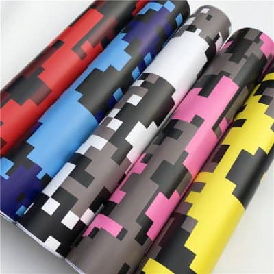Vivid pixelated wallpaper rolls in red, blue, black, pink, and yellow featuring modern digital mosaic design for interior decor or customized wall coverings.