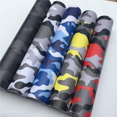 Camouflage patterned wallpaper rolls for interior decor and home improvement.