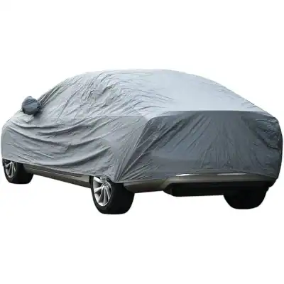 Covered car with protective gray outdoor car cover for protection against dust, weather, and scratches, ideal for vehicle maintenance and care.
