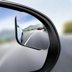 High-quality car side mirror with a clear view of highway and passing vehicles, promoting driving safety and visibility. Perfect for automotive accessories and enhancing road safety.