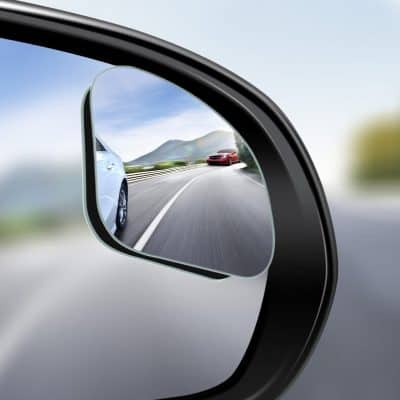 High-quality car side mirror with a clear view of highway and passing vehicles, promoting driving safety and visibility. Perfect for automotive accessories and enhancing road safety.