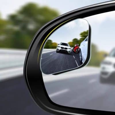 White luxury car driving on highway with red sports car in side mirror reflection, car insurance, road safety, vehicle driving, automotive insurance, Monalisa Store eye-catching visuals for auto insurance website.