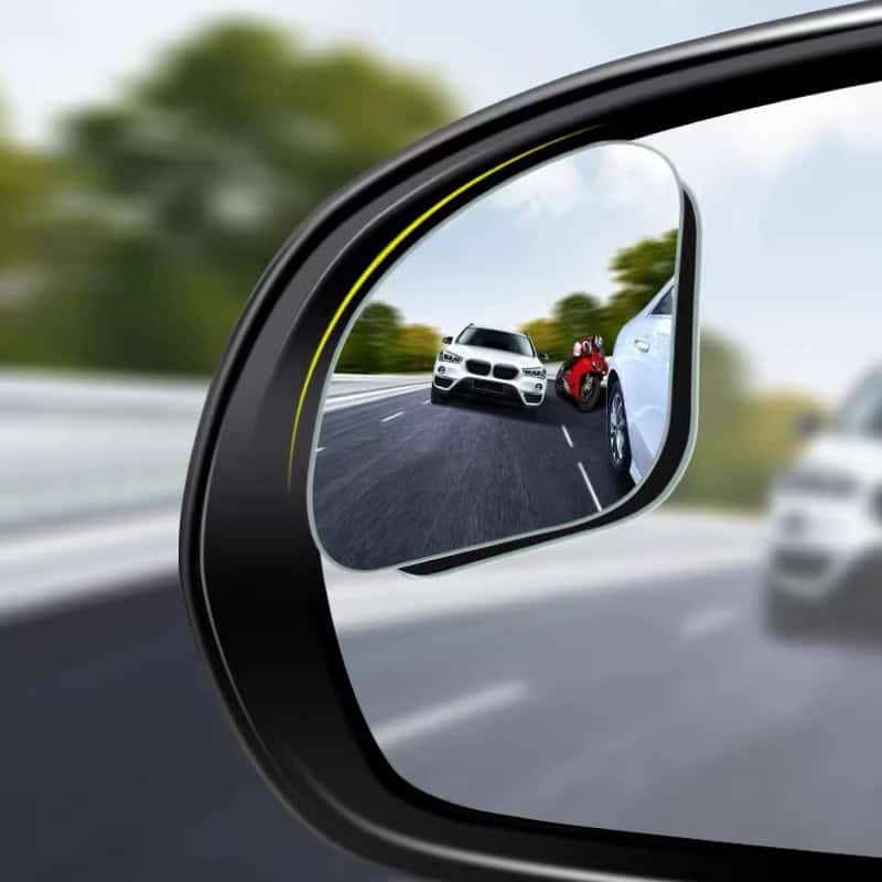 White luxury car driving on highway with red sports car in side mirror reflection, car insurance, road safety, vehicle driving, automotive insurance, Monalisa Store eye-catching visuals for auto insurance website.