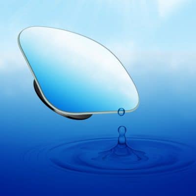 Anti-reflective coated sunglass lens reflecting sunlight, with water droplet effect, showcasing advanced optical clarity for eye protection.