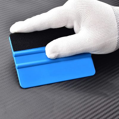 Extra sticky black foam pad for lens cleaning on a blue plastic lens cleaning tool.