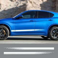 A sleek blue sports car driving on a mountain road, showcasing modern automotive design and high performance.