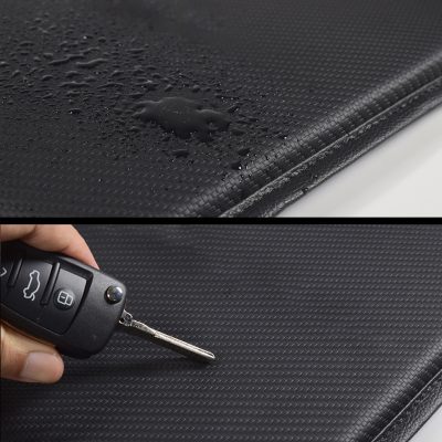 Water-resistant car dashboard mat with textured surface for protection and durability and a close-up of a car key on the mat, emphasizing its suitability for vehicle interior accessories.
