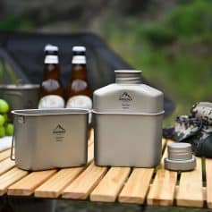 Stainless steel camping cookware set with a portable design, including multi-use pots, cups, and utensils, ideal for outdoor activities and travel.