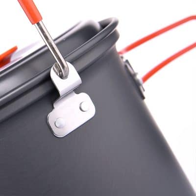 Metal buckle and red rubber tubing on medical or industrial equipment, close-up shot.