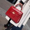 Luxurious red crocodile-embossed leather handbag with gold hardware, perfect for elegant fashion statements at Monalisa Store.