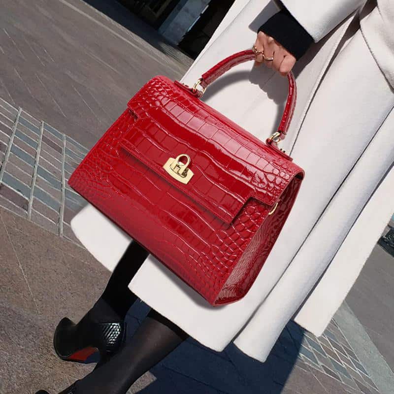 Luxurious red crocodile-embossed leather handbag with gold hardware, perfect for elegant fashion statements at Monalisa Store.