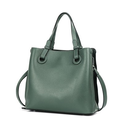 Green leather handbag with handles and detachable strap for women’s fashion and accessories.